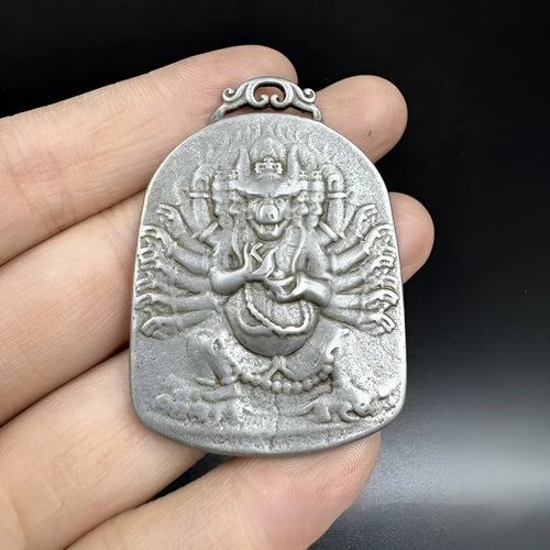 Close-up of an antique iron pendant with Chinese geometric patterns, design Aryaacalanatha Yamantaka.