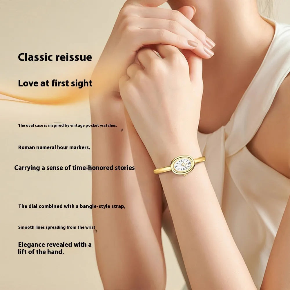Women's gold and silver oval retro quartz watch with spiral patterns on a 8mm thick case.