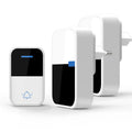 White wireless doorbell kit with plug-in chime and push button on a wooden table