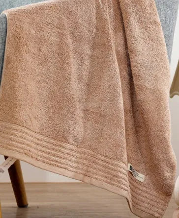Cotton towel set showing three sizes in beige and brown colours for bathroom use