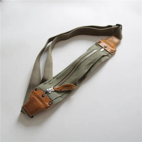 Green military style chest bag made from canvas with leather accents and anti-theft functionality