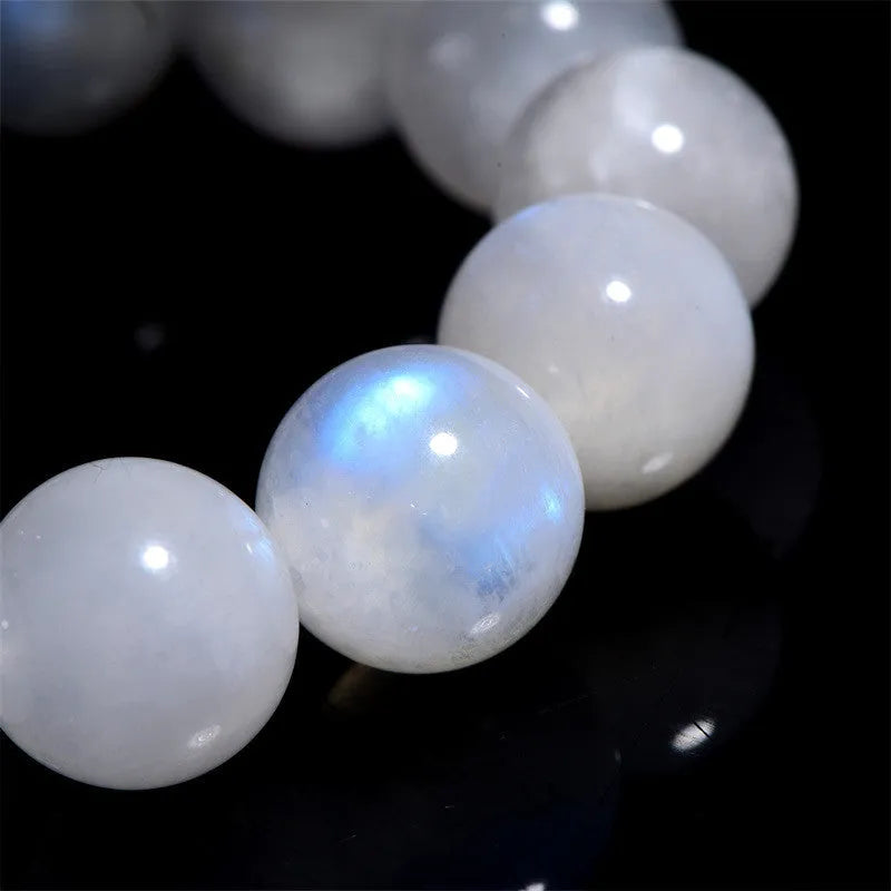 Natural white Blue Moonlight Moonstone round bead bracelet on wrist, showing polished gemstone beads.
