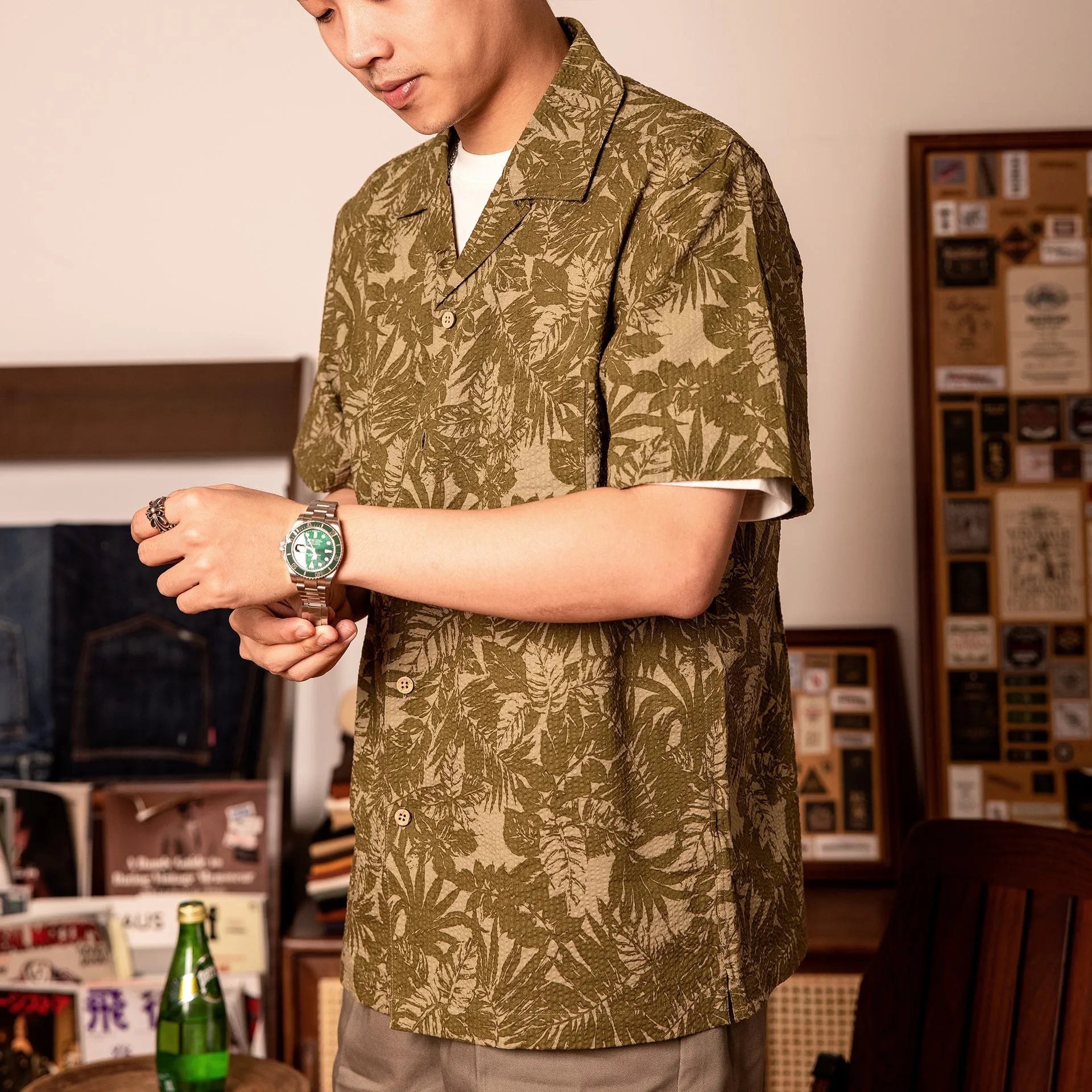 Man wearing a vintage floral print seersucker shirt with a Cuban collar in a loose, casual fit.