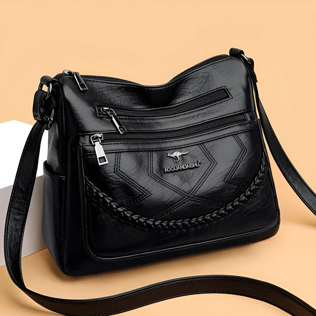 Soft leather crossbody shoulder bag in horizontal square design with zippered internal pocket