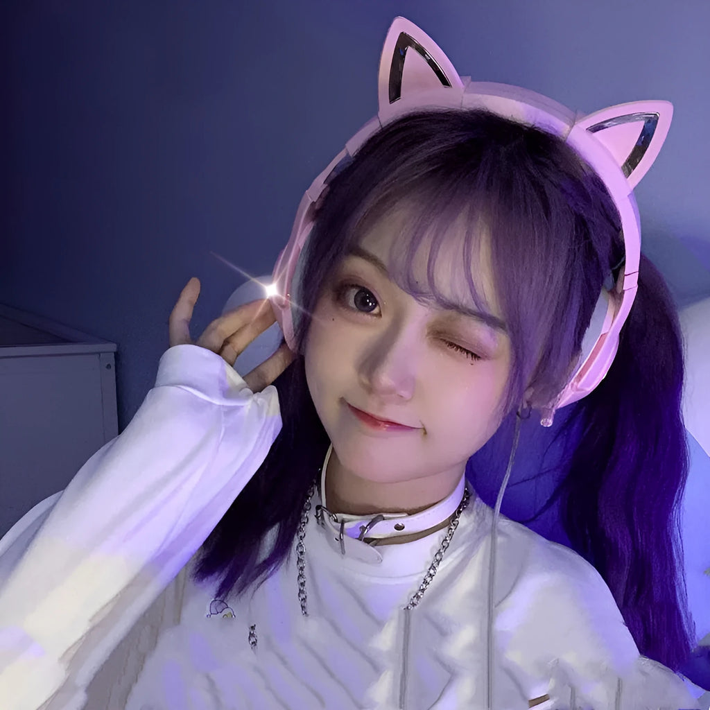 Pink cat ear wired headphones with microphone and LED lights on a stand
