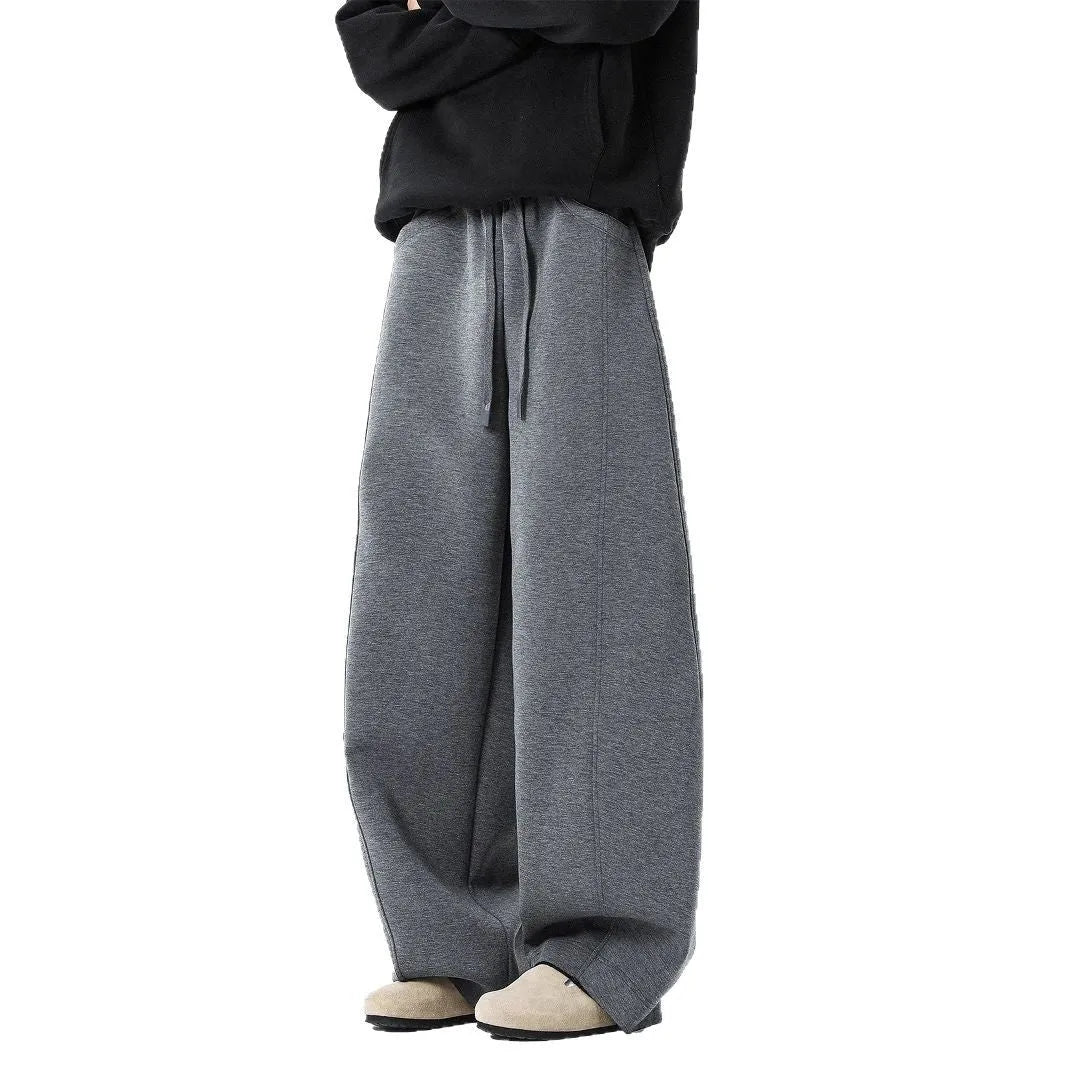 Men's relaxed dark grey or black trousers with drawstring waist, slight stretch, and included belt