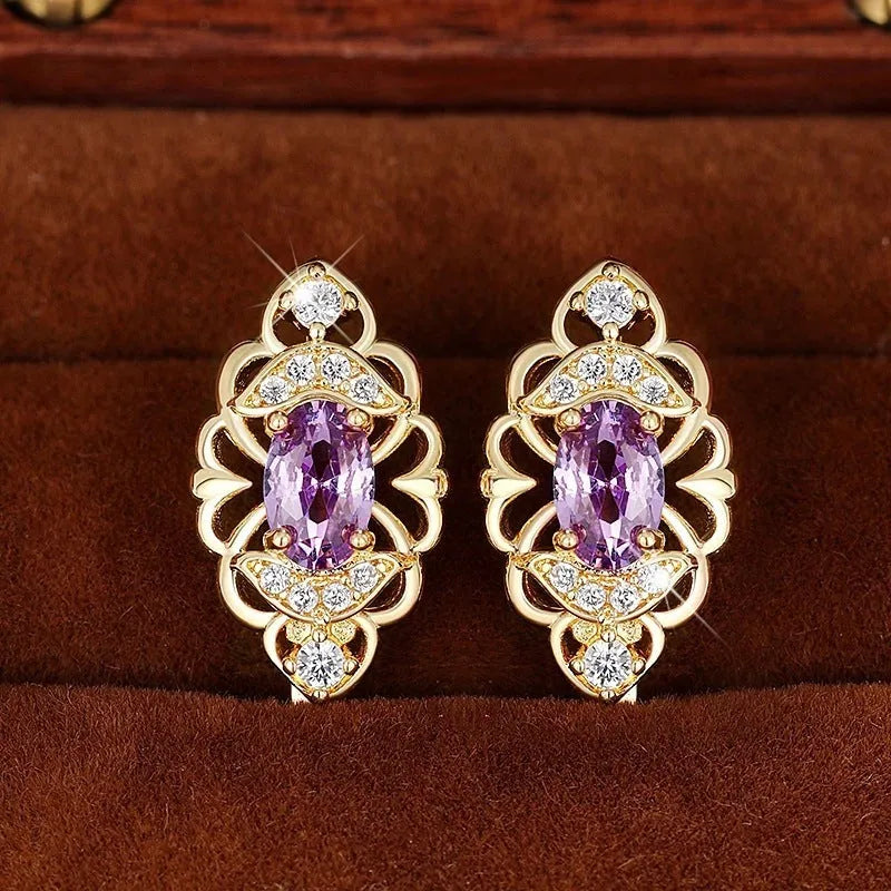 Gold copper flower earrings with hollow design and zircon stones on white background