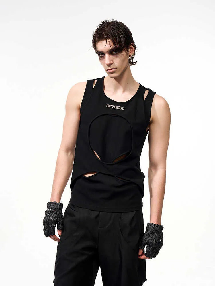 Man wearing a black sleeveless pullover waistcoat with a round neck, showcasing the loose fit and hollow thread texture.