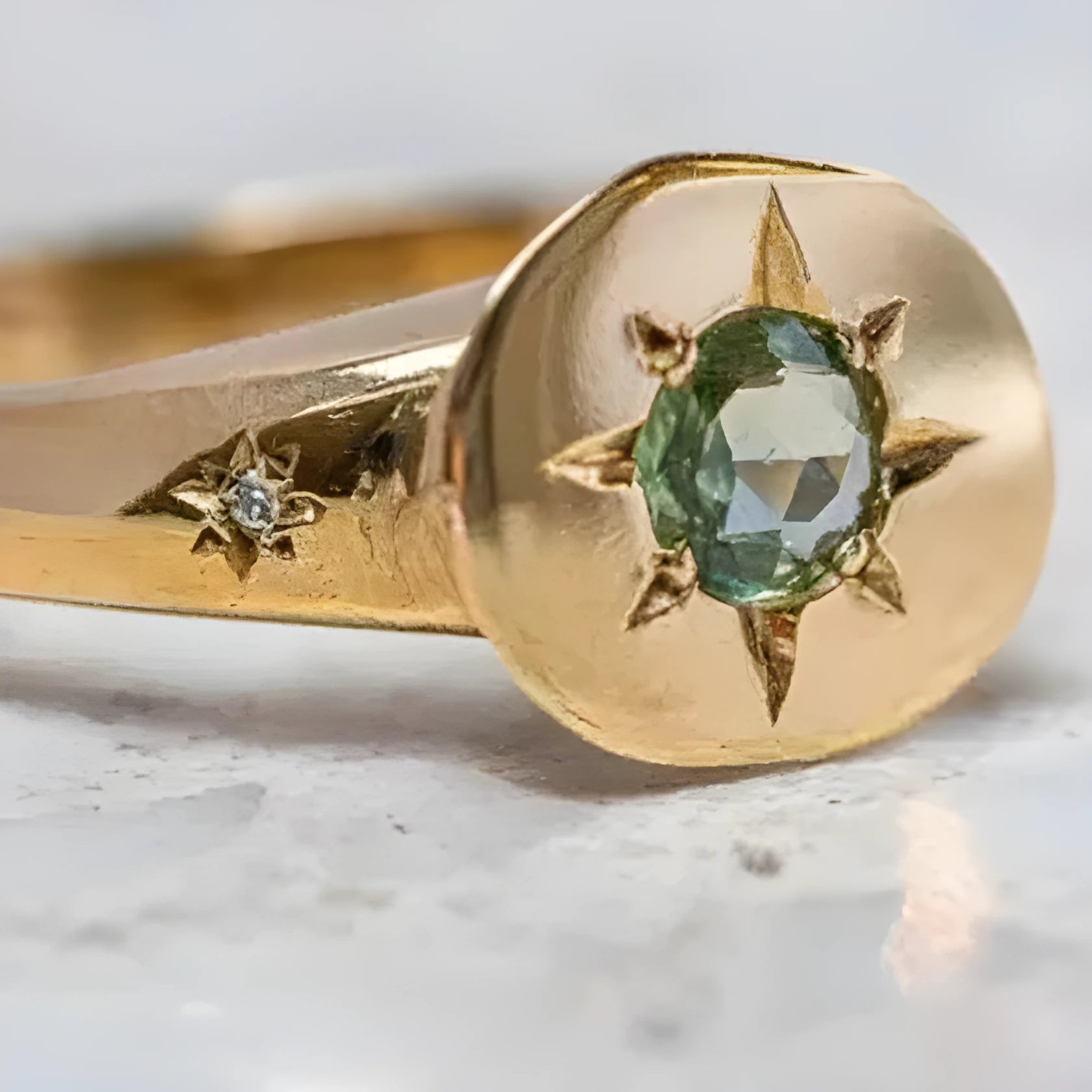 Gold coloured adjustable ring with a star-shaped zircon stone set via micro-inlay on a simple oval band.