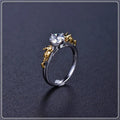 Detailed close-up of a black gold copper crown ring with a central crystal on a finger.