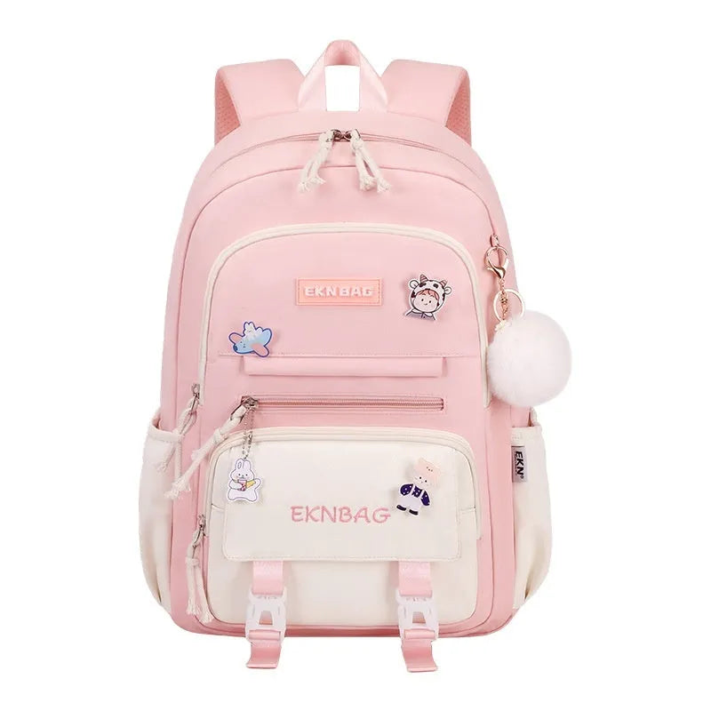 A girls' school backpack in Oxford cloth, featuring curved shoulder straps, shown in a choice of colours including pink, blue, and black.