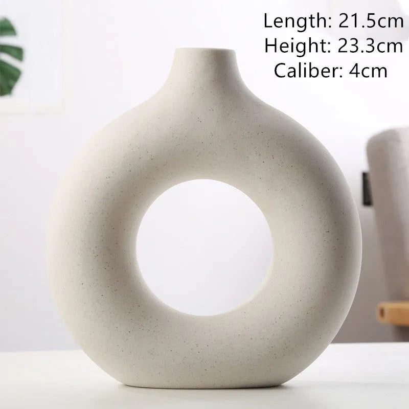 Frosted unglazed porcelain biscuit vase in a simple modern style on a table.