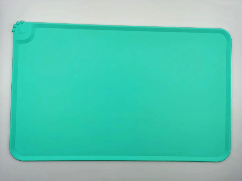 Silicone pet placemat in grey colour under a dog food bowl, showing raised edge.