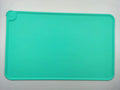 Silicone pet placemat in grey colour under a dog food bowl, showing raised edge.