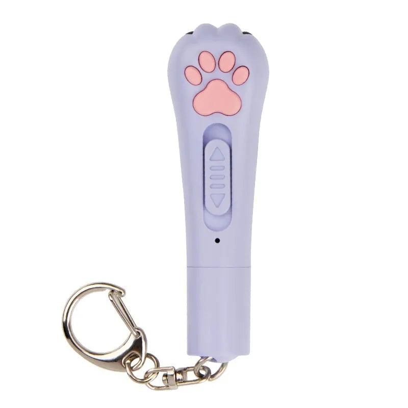 Small white infrared laser cat teasing stick with LED light, shown on a table with a USB charging cable.