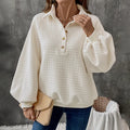 Women's solid colour polo collar sweater with long sleeves in a textured knit.