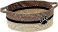 Light beige handmade woven cotton rope storage basket with a wooden handle on a wooden floor.