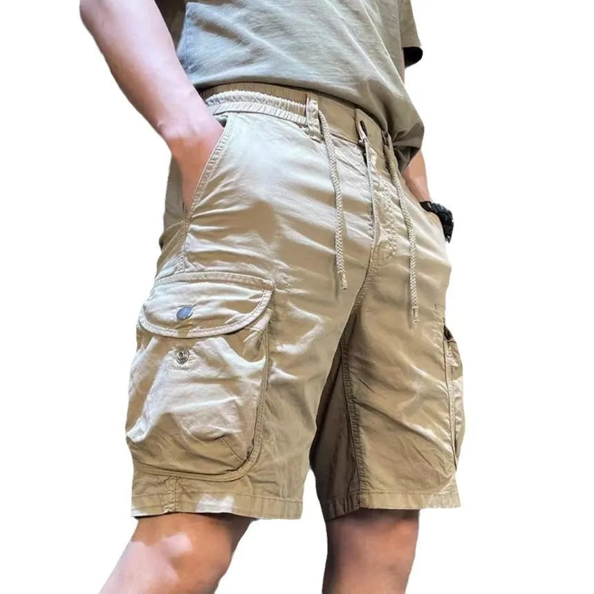 Korean style loose straight leg overalls trousers in khaki with multiple pockets, shown on a model.