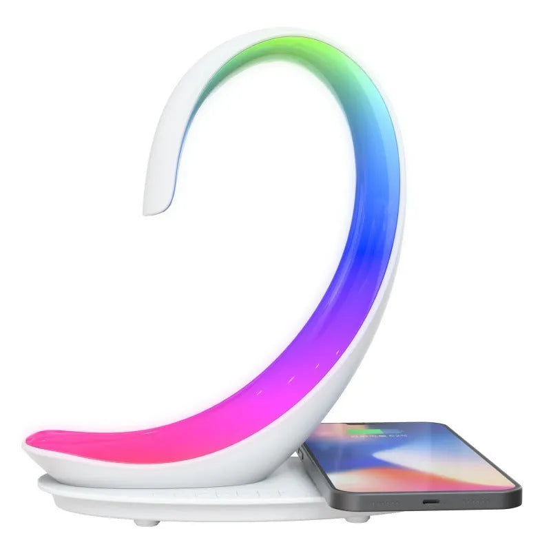 White swan-shaped desktop wireless charger with integrated Bluetooth speaker and colourful LED atmosphere light.