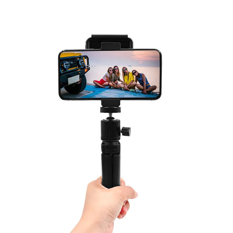 Aluminium alloy handheld bracket accessory for mounting an iPhone onto a table top tripod.