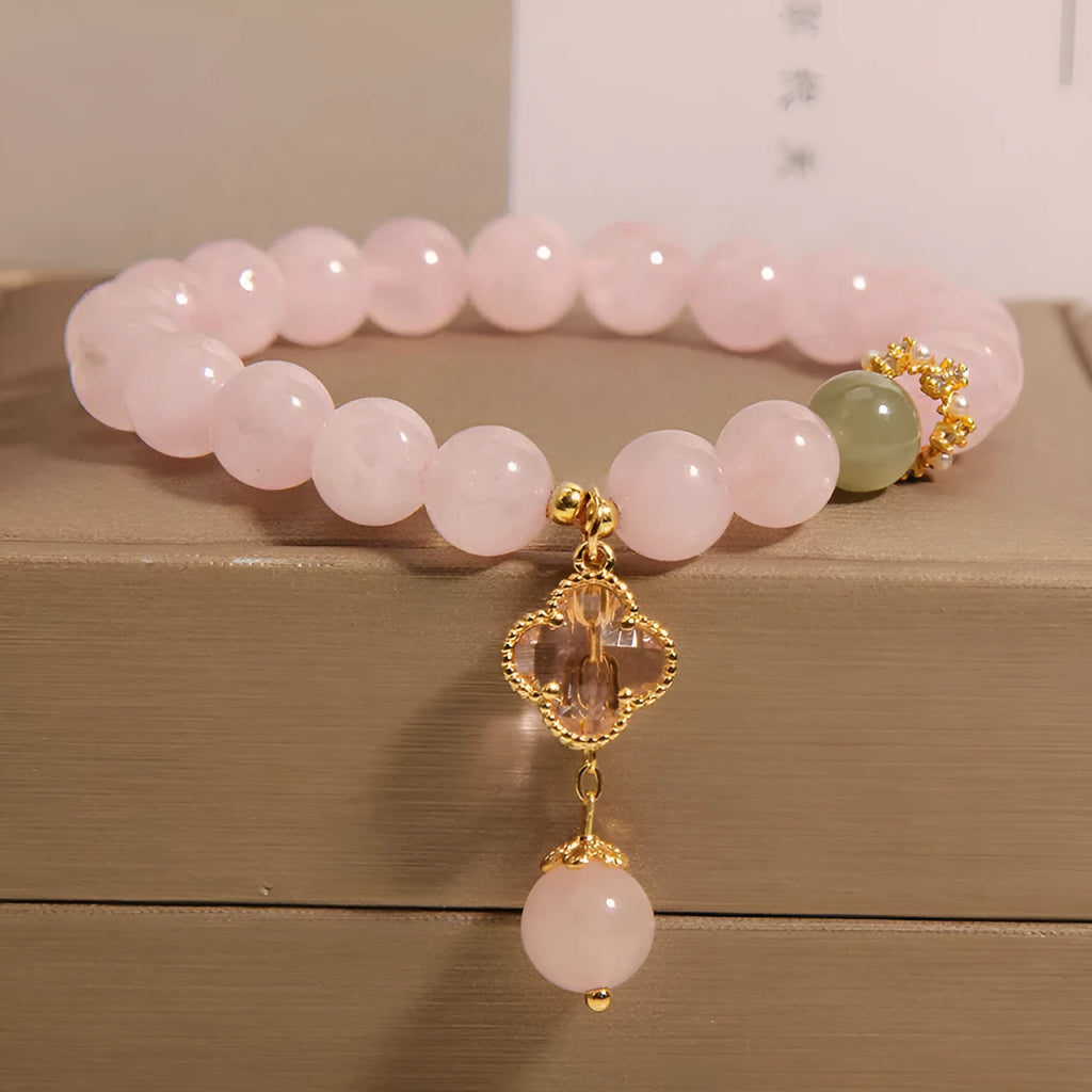 Pink crystal bracelet for women with a four-leaf clover pendant, alloy inlay, and rhinestones.
