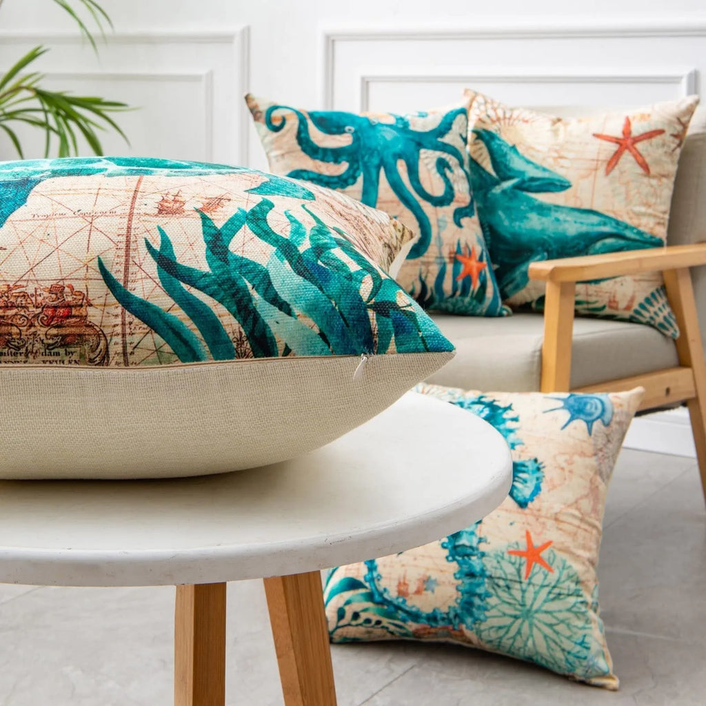 Linen cushion cover with detailed sea turtle print, measuring 45x45cm, on a sofa.