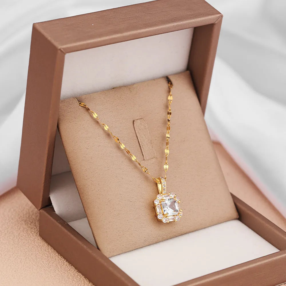 Women's geometric titanium steel clavicle necklace with gemstone-inlaid pendant on a water wave chain.