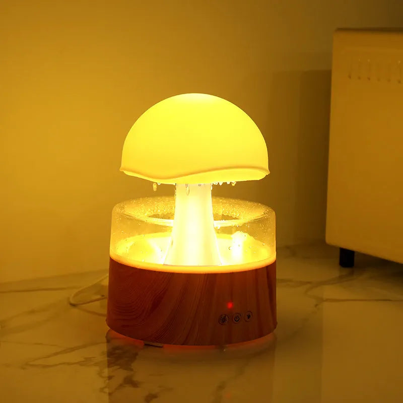 White cloud-shaped humidifier and aroma diffuser with falling water droplets and coloured lights