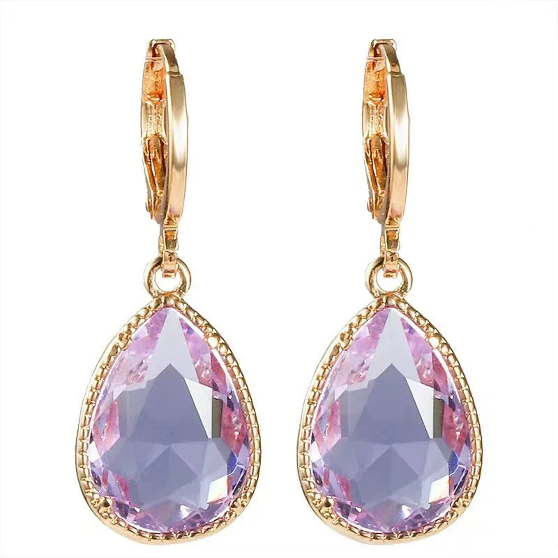 Copper-coloured rare earth metal and glass geometric saturn water drop earrings in multiple colours.