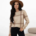 Women's loose fit plaid sweater with apricot, black, beige, red, and green colour-block stripes.