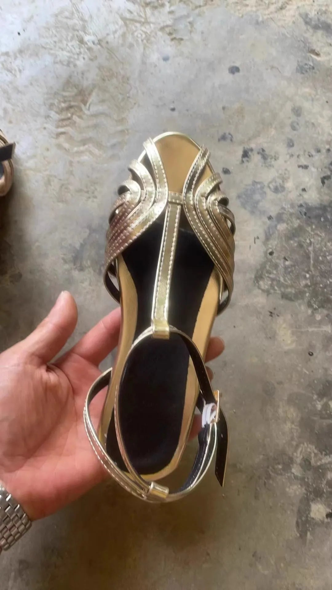Gold flat peep toe ankle buckle hollow women's sandals with PU upper and rubber sole on a light background