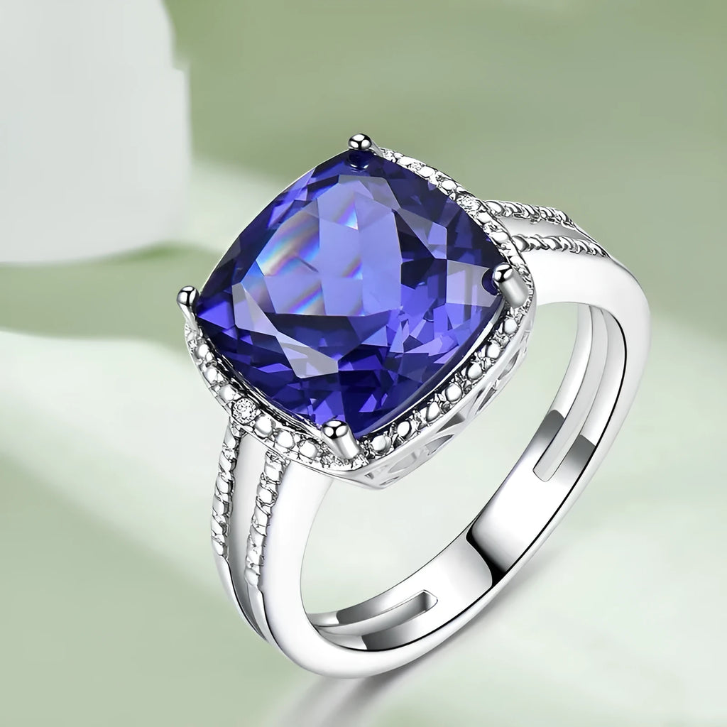 A women's sterling silver ring with a blue Tanzanite gemstone on a silver band.