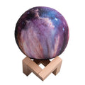 3D-printed lunar sphere night light showing colour-changing LEDs with a remote control.