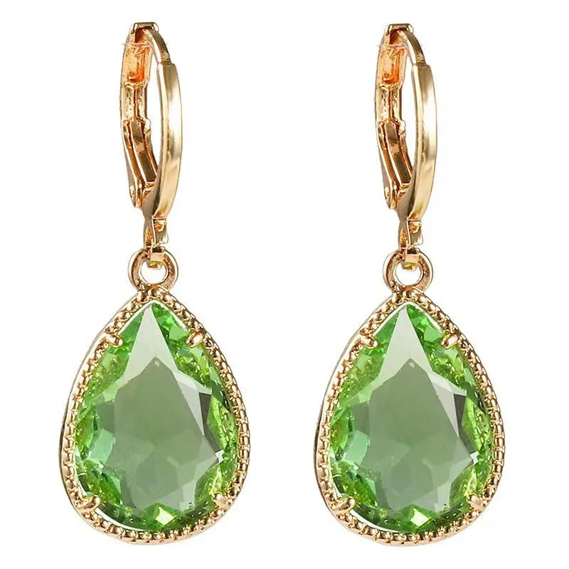 Copper-coloured rare earth metal and glass geometric saturn water drop earrings in multiple colours.