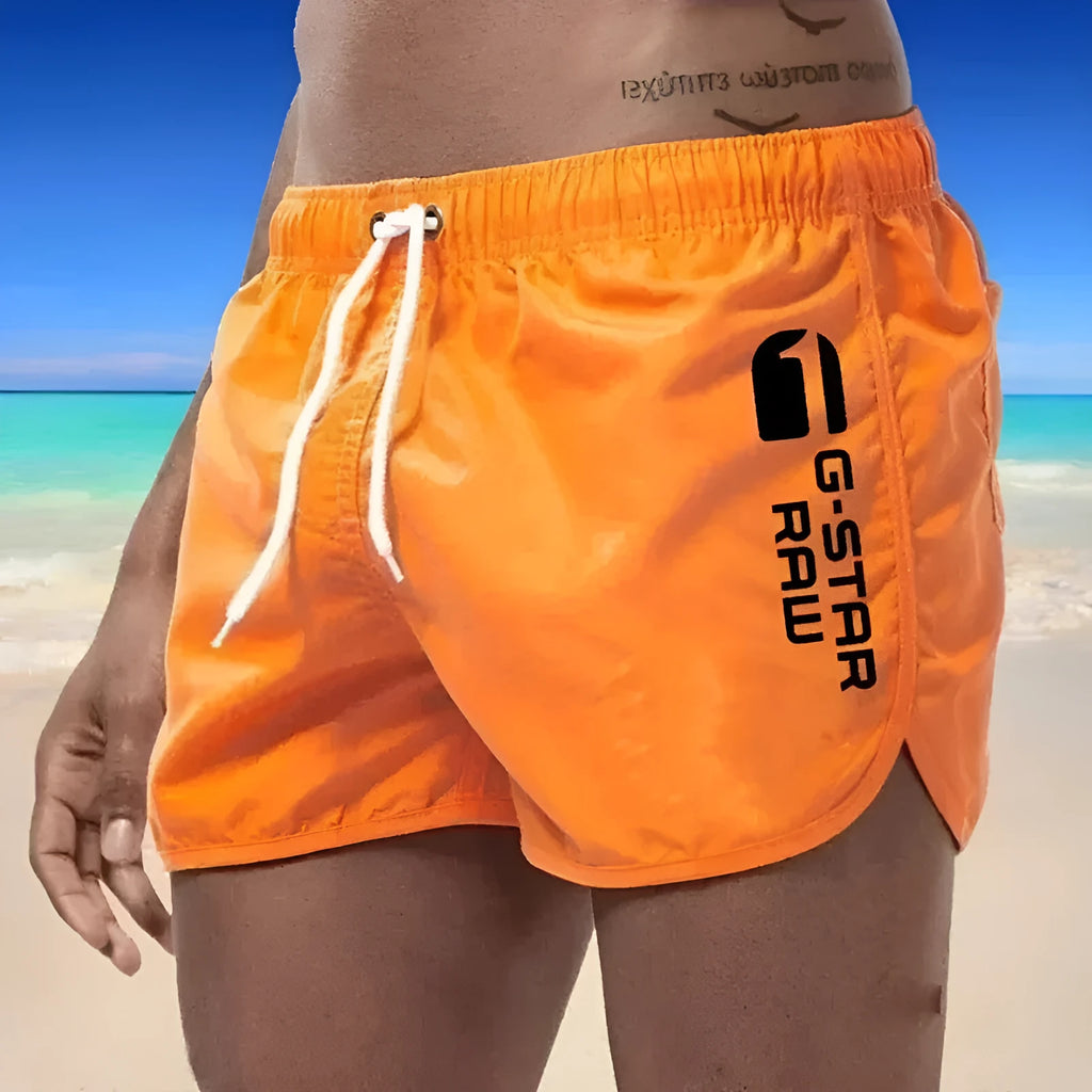 Man wearing thin polyester sports shorts with an elastic waistband in a bright colour like fluorescent green.