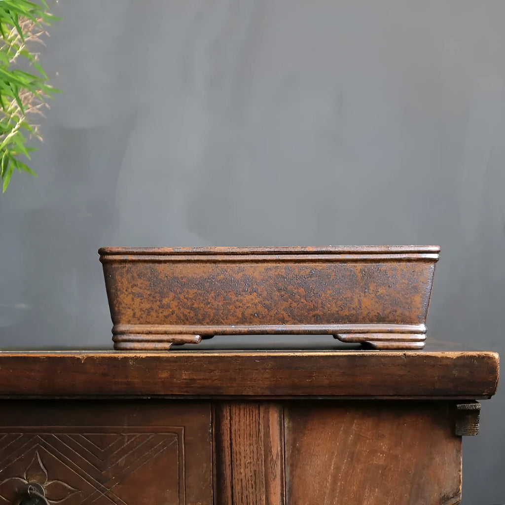 Rectangular purple sand bonsai pot with five-line textured pattern, shown empty on a wooden surface.