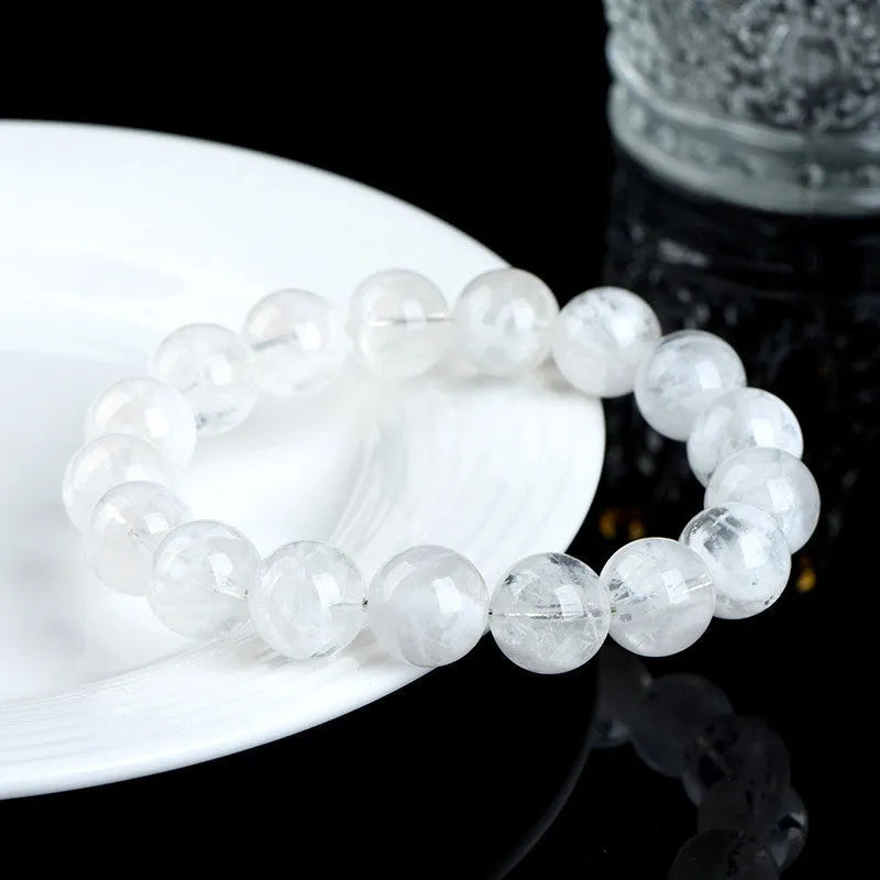 Women's crystal bracelet with round snowflake beads and a traditional Ruyi charm.