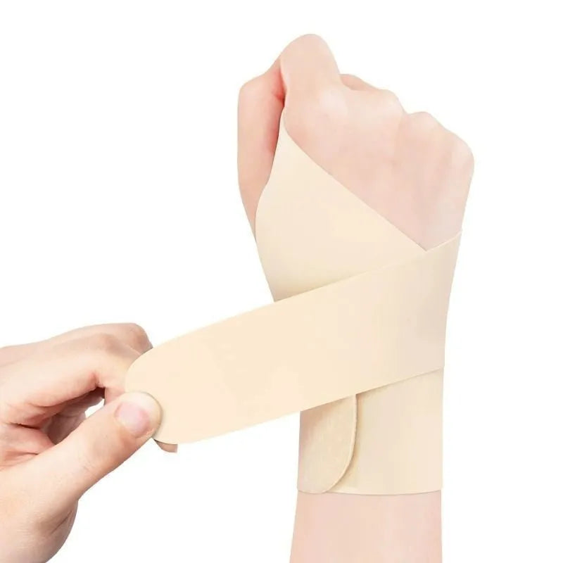 Adjustable black athletic wristguard worn on a wrist during exercise.