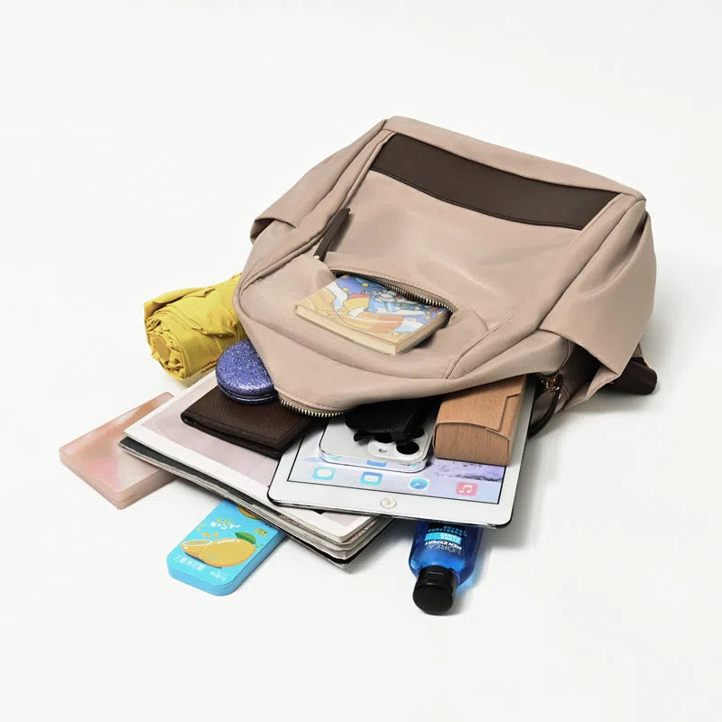Women's large-capacity nylon travel backpack in black or milk tea colour with polyester lining and internal patch pocket.