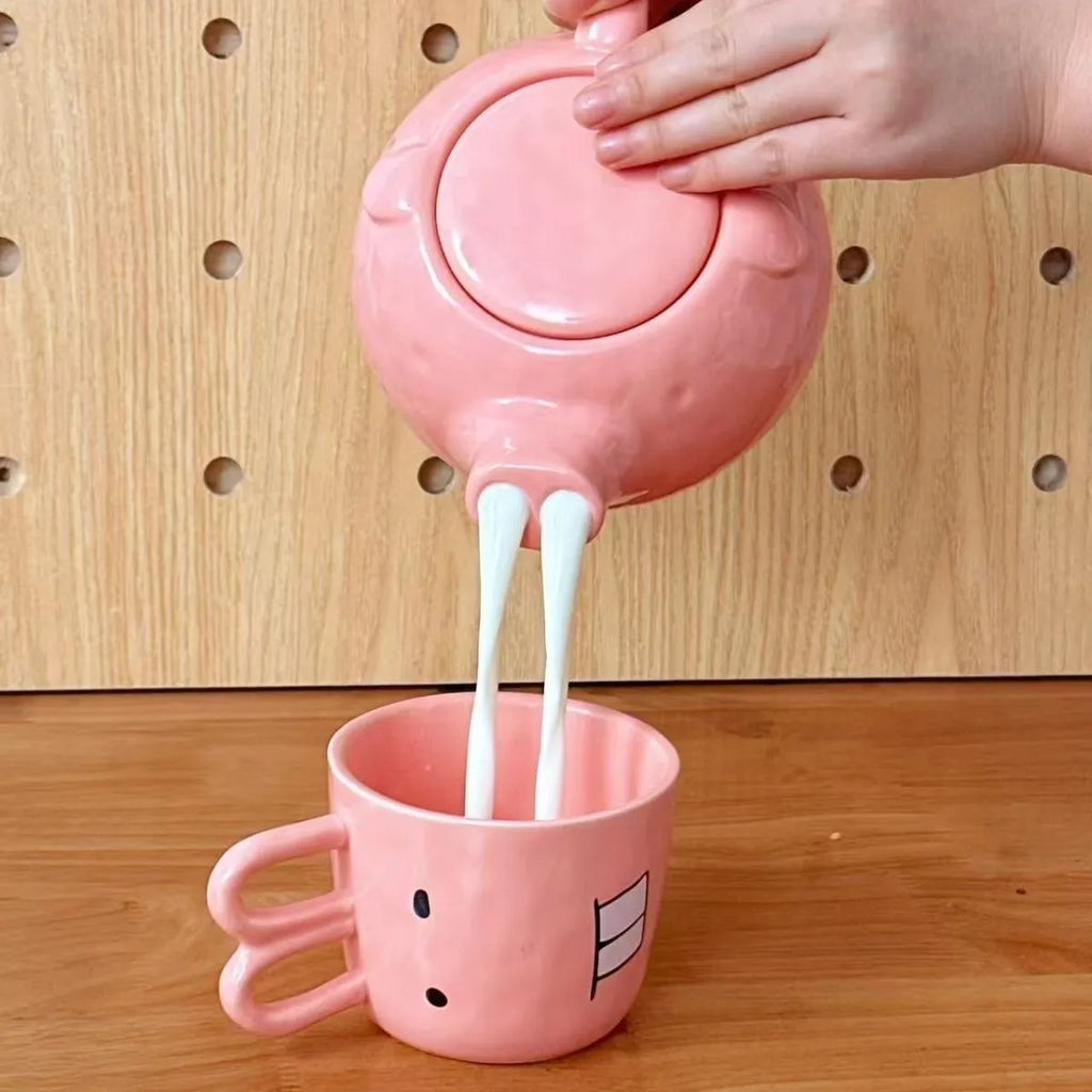 Creative ceramic piggy teapot nose mug set with pink pig pot and rabbit cup on a table