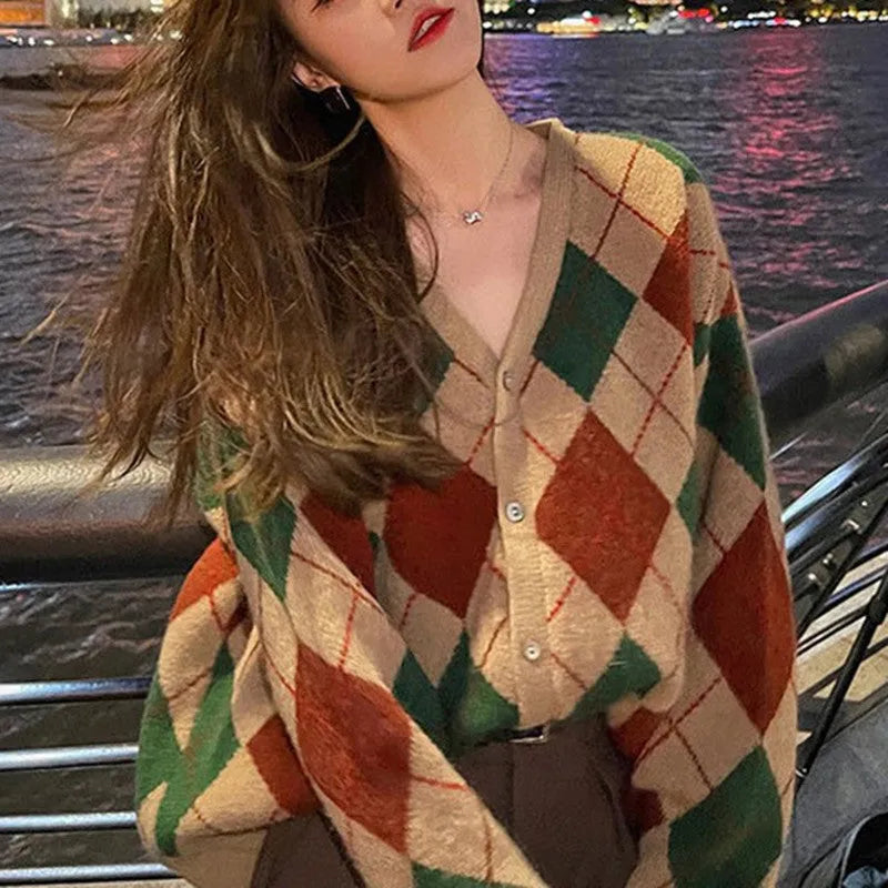 A knitted casual cardigan coat in a macaron colour, shown on a hanger with regular sleeves.