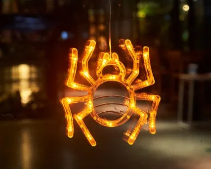 Halloween LED window lights with suction cups showing ghost, spider, and pumpkin decorations