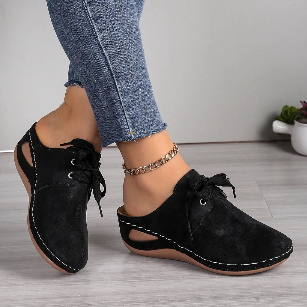 Women's black suede lace-up wedge sandals with a hollow-out design and rubber sole.
