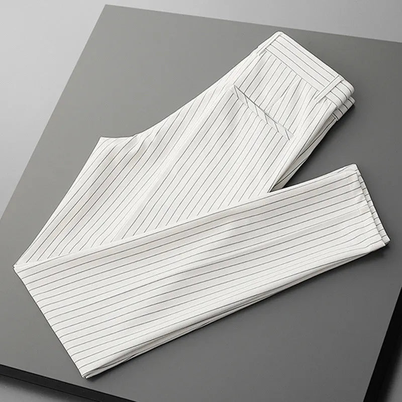 Men's thin striped loose suit pants with draping fit in black and white colours.