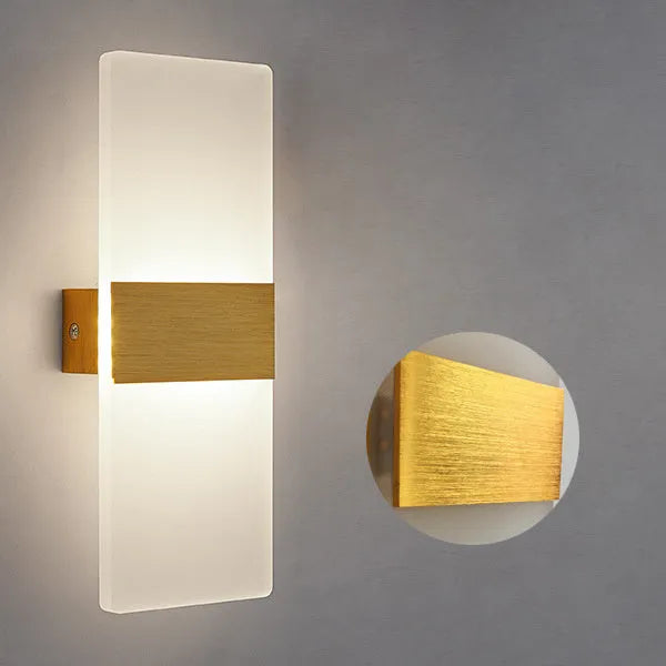 Modern acrylic wall-mounted LED bedside lamp in silver finish showing warm light illumination