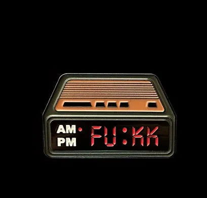 Black metal retro electronic alarm clock brooch pin with original design on a jacket lapel