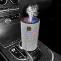 Compact white car USB air humidifier on a car dashboard.