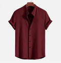 A man's loose-fitting short sleeve casual shirt in a solid colour, made from lightweight polyester fabric.
