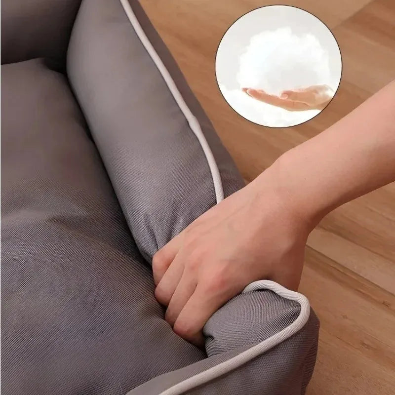 Grey waterproof dog sofa bed with a soft cushion, shown next to a sleeping golden retriever.