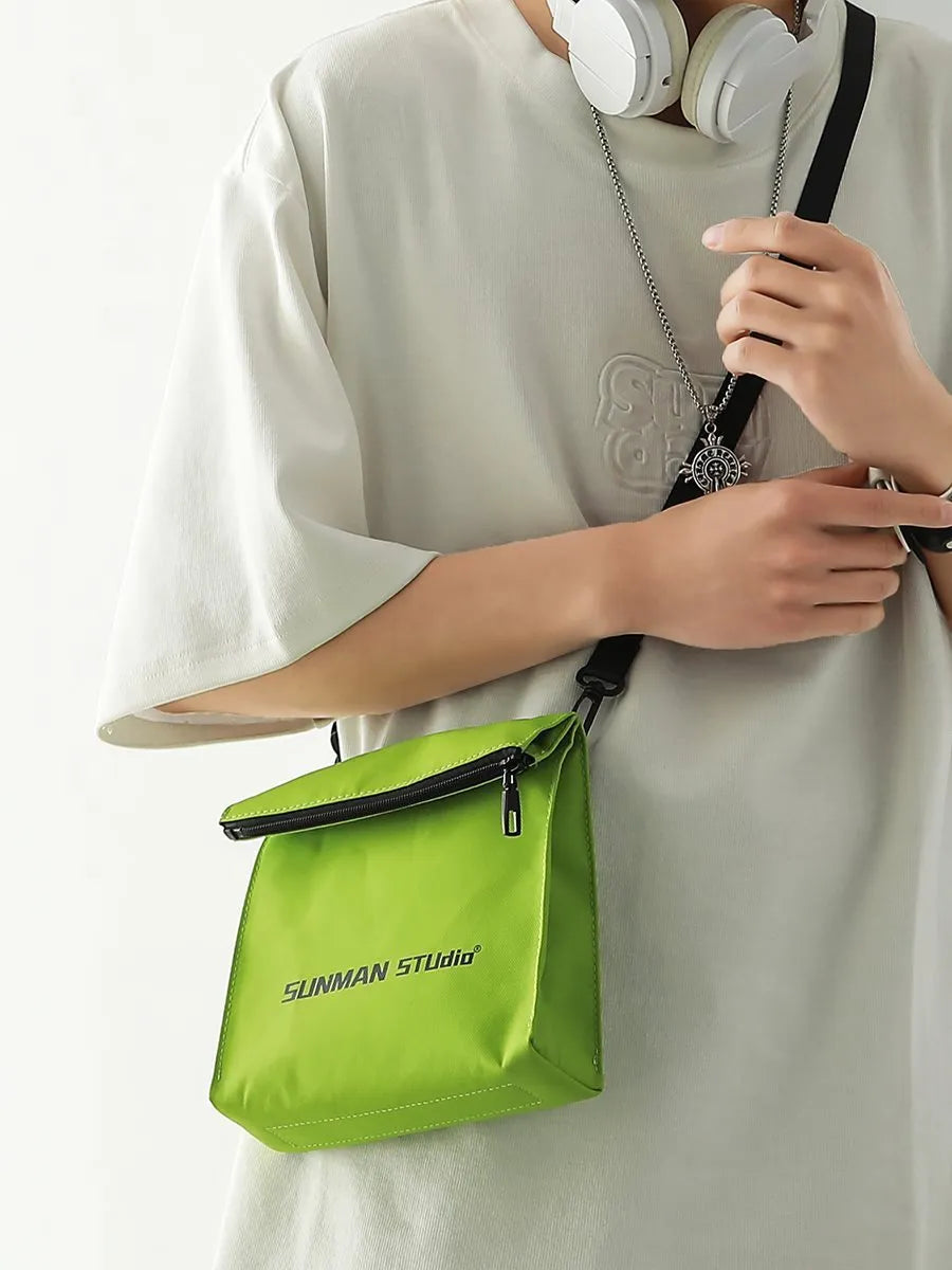Simple messenger backpack in Oxford fabric with contrast stitching, shown in a choice of four colours.